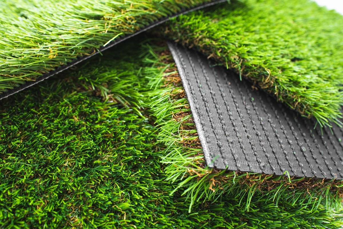 Artificial grass flooring installed by a lawn care service, showcasing a vibrant and low-maintenance outdoor space.
